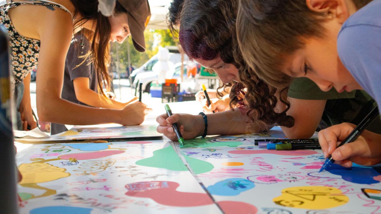 Community members painting during Moo-seum grand opening.